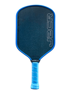 A pickleball paddle with a dark blue textured face, a bright blue border, and a blue wrapped handle, featuring the J2CR logo vertically on the right side.
